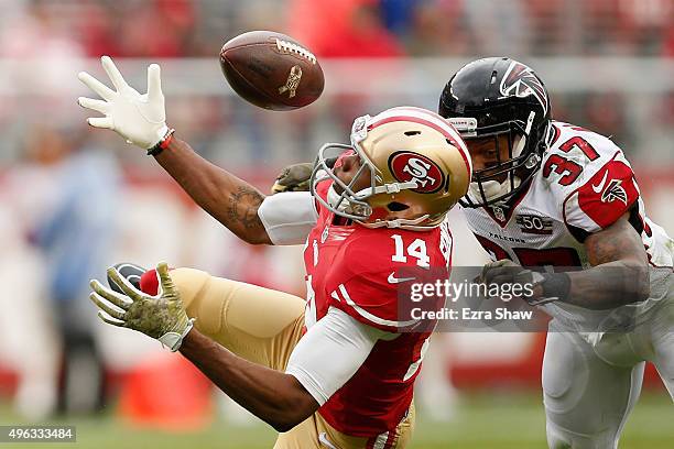 Jerome Simpson of the San Francisco 49ers catches the ball and then is hit by Ricardo Allen of the Atlanta Falcons and then Phillip Adams of the...