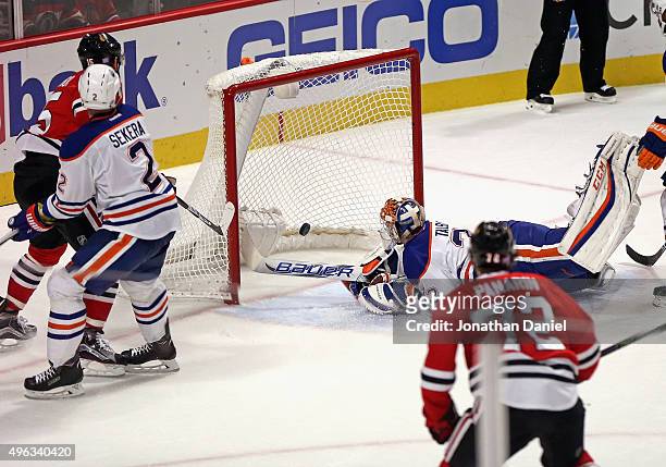 Artem Anisimov of the Chicago Blackhawks puts the puck past Cam Talbot of the Edmonton Oilers late in the third period at the United Center on...