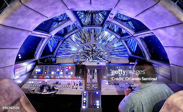 Danny Handke, a creative design executive with Walt Disney Imagineering, demonstrates the hyper reality of the cockpit in the new Star Wars...