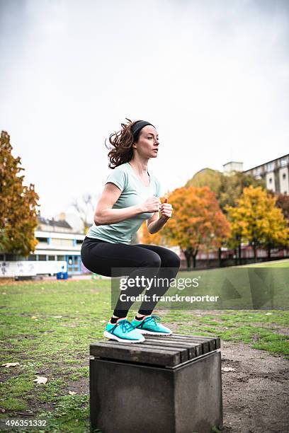 woman doing a   exercise in a park - crouching stock pictures, royalty-free photos & images