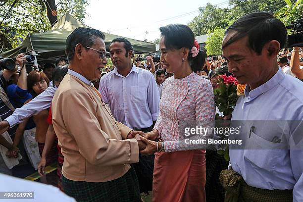 Aung San Suu Kyi, Myanmar's opposition leader and chairperson of the National League for Democracy , center right, greets Tin Oo, co-founder of the...