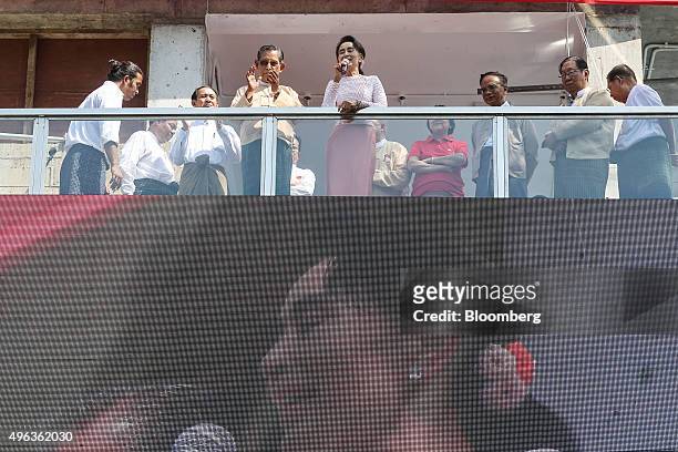 Aung San Suu Kyi, Myanmar's opposition leader and chairperson of the National League for Democracy , center, delivers a speech flanked by Tin Oo,...