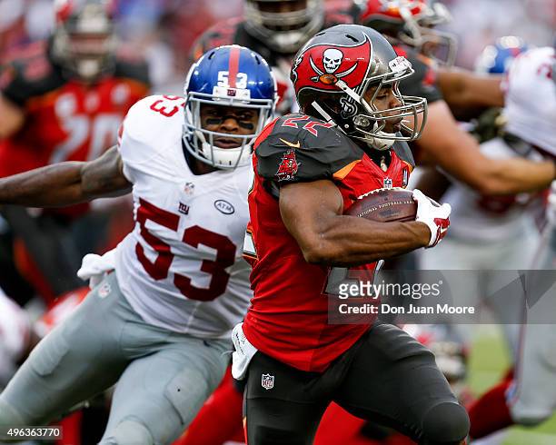 Runningback Doug Martin of the Tampa Bay Buccaneers avoids a tackle by Linebacker Jasper Brinkley of the New York Giants during the game at Raymond...