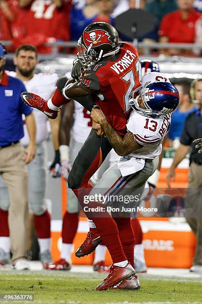 Wide Receiver Odell Beckham of the New York Giants makes a hard tackle against Cornerback Alterraun Verner of the Tampa Bay Buccaneers, who made an...