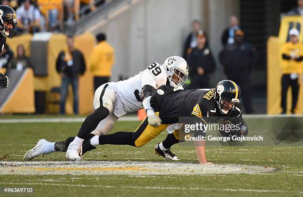 Linebacker Aldon Smith of the Oakland Raiders sacks quarterback Ben Roethlisberger of the Pittsburgh Steelers during a game at Heinz Field on...