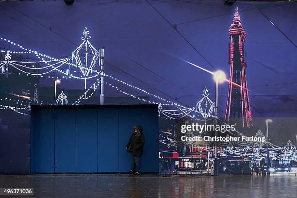 Woman shelters in a doorway against driving rain and high winds in Blackpool, as Britain's first ever named storm, Storm Abigail, hits the North West...