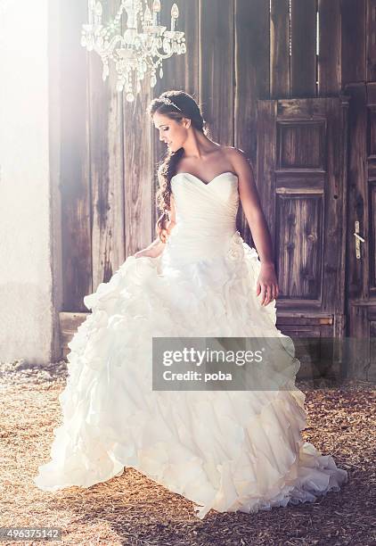 woman standing in her long wedding dress - wedding dress stock pictures, royalty-free photos & images