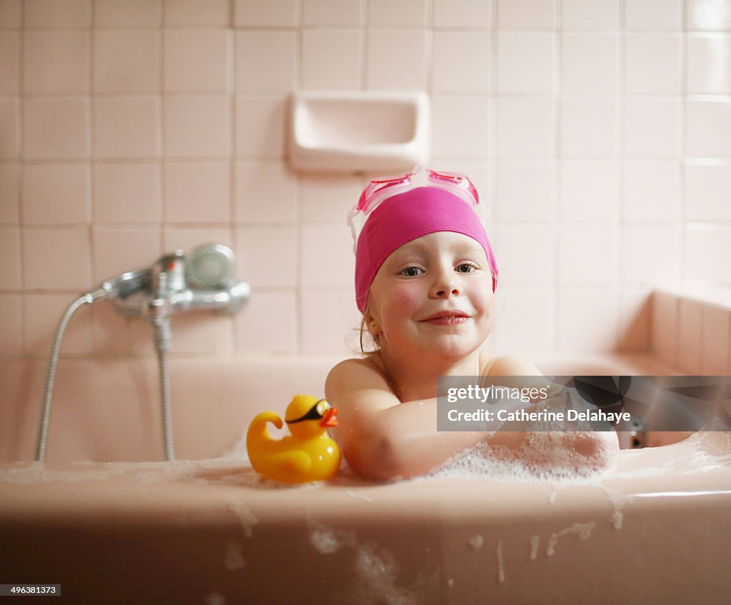 A 5 years old girl taking her bath