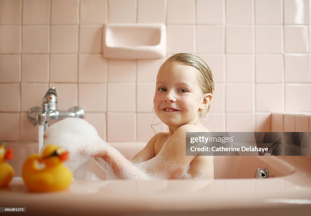 A 5 years old girl taking her bath