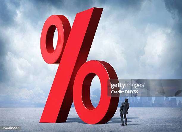 businessman looking up at percent sign - interest rate stock pictures, royalty-free photos & images