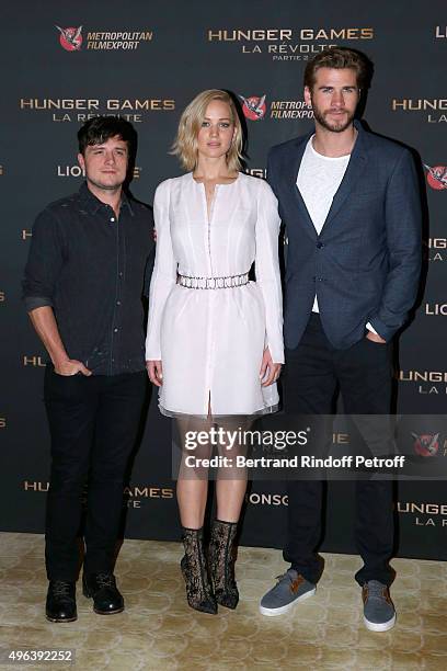 Actors Josh Hutcherson, Jennifer Lawrence, makeup and dressed in Dior, and Liam Hemsworth attend the 'Hunger Games : Mockingjay Part 2', Paris :...