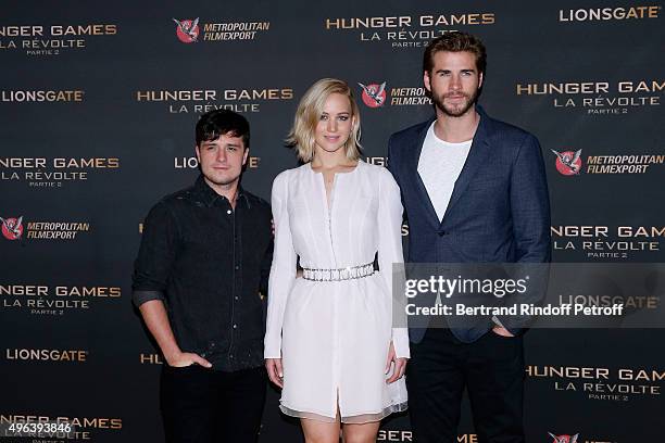 Actors Josh Hutcherson, Jennifer Lawrence, makeup and dressed in Dior, and Liam Hemsworth attend the 'Hunger Games : Mockingjay Part 2', Paris :...