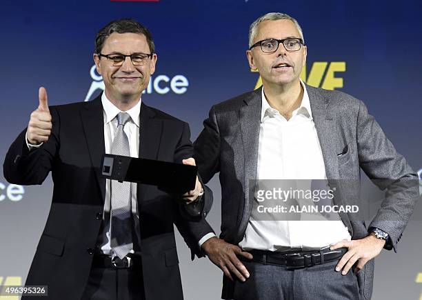The CEO of the French telecommunications company SFR Eric Denoyer and Michel Combes, both Chief Operating Officer of the Group Altice and Chairman of...
