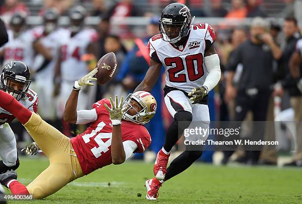 Phillip Adams of the Atlanta Falcons intercepts this pass that was deflected off the hands of Jerome Simpson of the San Francisco 49ers during the...