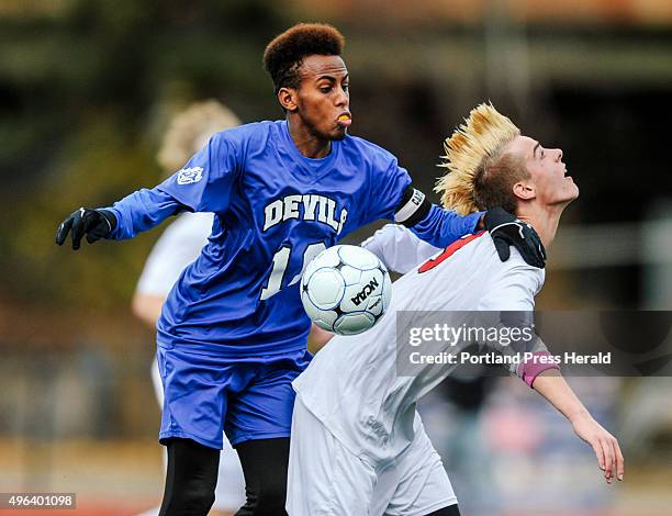 Scarborough defender Spencer Pettingill and Lewiston striker Abdi Shariff-Hassan fight for the ball at Fitzpatrick Stadium in Portland, ME on...