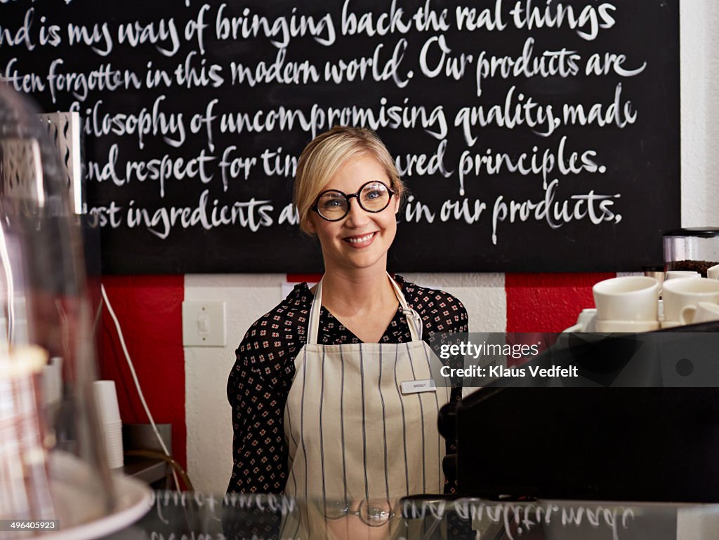 Portrait of coffee shop owner with big glasses