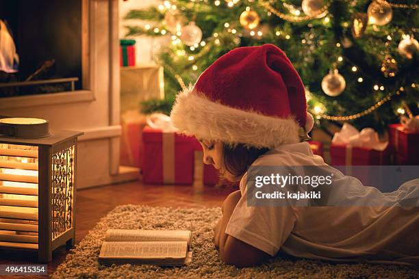 beautiful little girl reading a book - book candlelight stock pictures, royalty-free photos & images