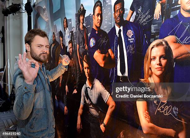 Actor Patrick John Flueger signs a poster as she attends a press junket for NBC's 'Chicago Fire', 'Chicago P.D.' and 'Chicago Med' at Cinespace...