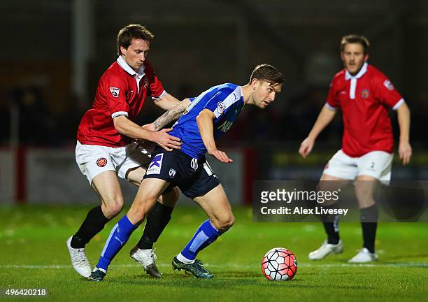Jay O'Shea of Chesterfield holds off Rory Fallon of FC United of Manchester during the Emirates FA Cup first round match between FC United of...