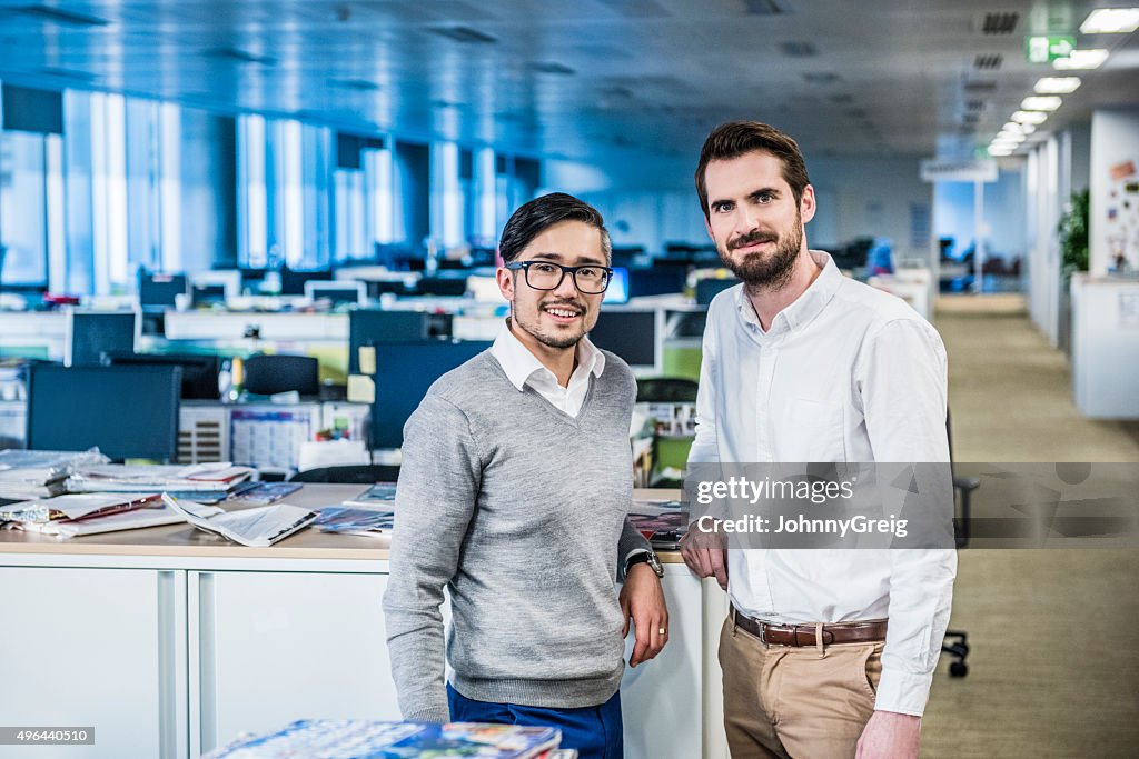 Two male business colleagues in modern office, portrait