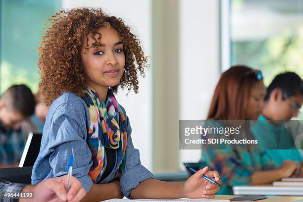 african american teenage girl smiling in classroom - beautiful college girls stock pictures, royalty-free photos & images