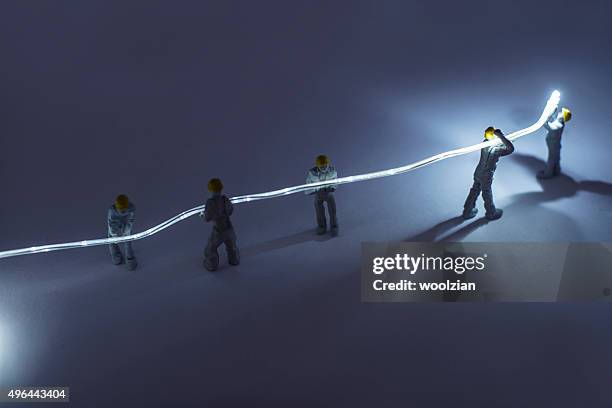 builders installing fibre optic - figurine stockfoto's en -beelden