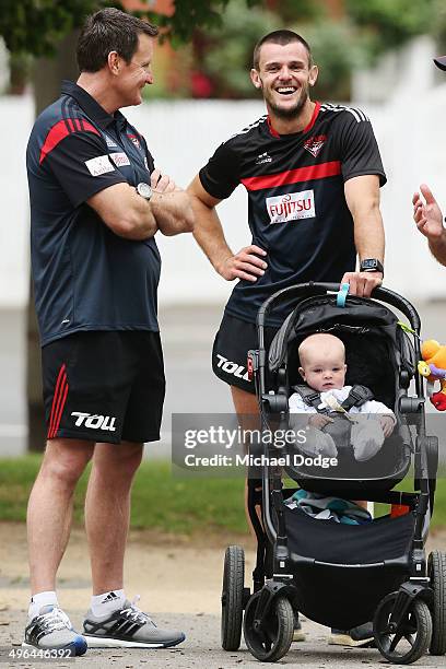 Brent Stanton, with his son Aiden in the pram, reacts to head coach John Worsfold during an Essendon Bombers AFL pre-season training session at...