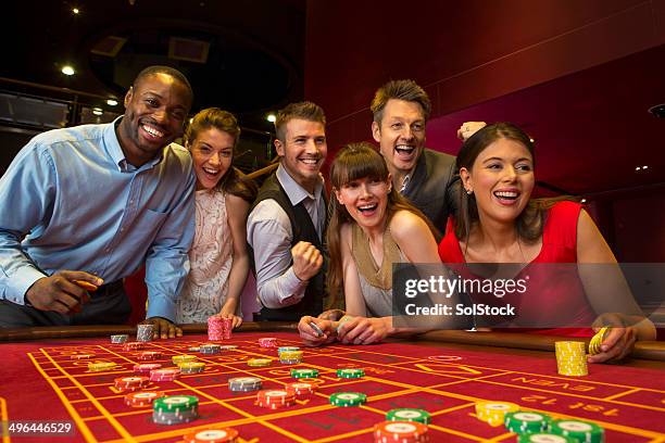 friends playing roulette - casino table games stockfoto's en -beelden