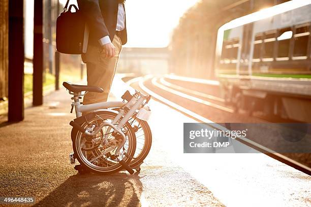 businessman waiting at railway station platform - opvouwbaar stockfoto's en -beelden