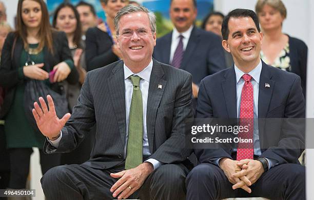 Wisconsin Governor Scott Walker sits with Republican presidential candidate Jeb Bush at La Casa de Esperanza during a campaign stop on November 9,...