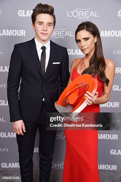 Brooklyn Beckham and designer Victoria Beckham pose backstage with her award at the 2015 Glamour Women Of The Year Awards at Carnegie Hall on...