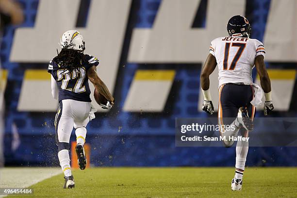 Jason Verrett of the San Diego Chargers runs back an interception for a touchdown while pursued by Alshon Jeffery of the Chicago Bears at Qualcomm...