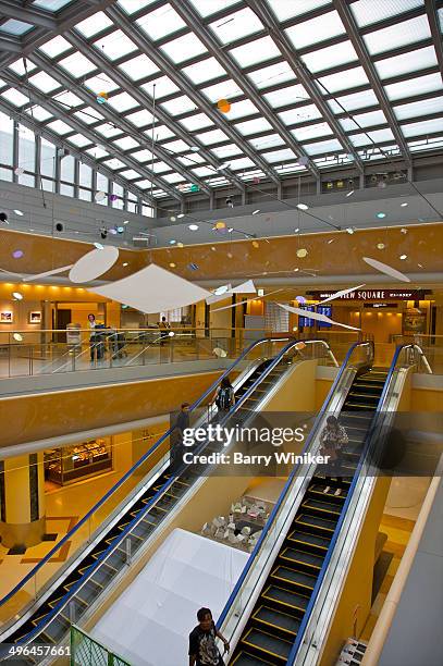 hanging artworks above escalators at airport - narita stock-fotos und bilder