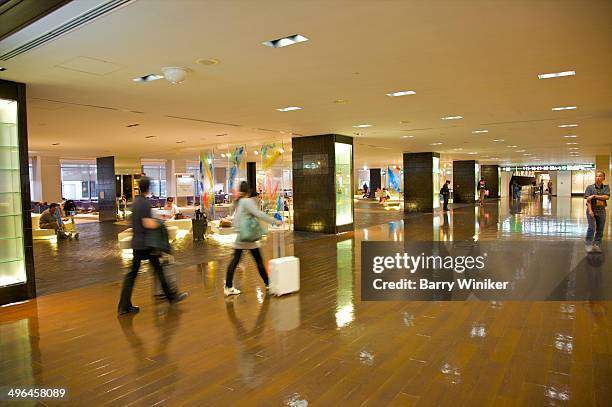 people walking past airport waiting area - narita international airport stock-fotos und bilder