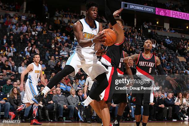 Emmanuel Mudiay of the Denver Nuggets dishes the ball off against Meyers Leonard of the Portland Trail Blazers at Pepsi Center on November 9, 2015 in...