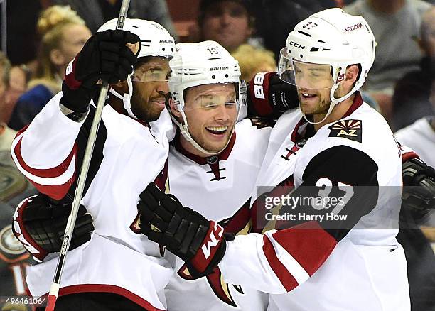 Max Domi of the Arizona Coyotes celebrates his goal second goal of the game with Anthony Duclair and Dustin Jeffrey to tie the game 2-2 with the...
