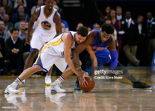 Klay Thompson of the Golden State Warriors and Andre Drummond of the Detroit Pistons go for a loose ball at ORACLE Arena on November 9, 2015 in...