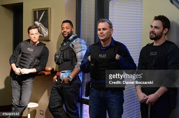 Actors Jesse Lee Soffer, Laroyce Hawkins, Chicago Police consultant Brian Luce and actor Patrick John Flueger perform an on set demonstration of...
