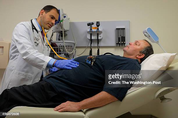Gary Ryan, R, gets a checkup from infectious disease doctor Fadi Al Akhrass, at the Pikeville Medical Center on Thursday, November 2015, in...