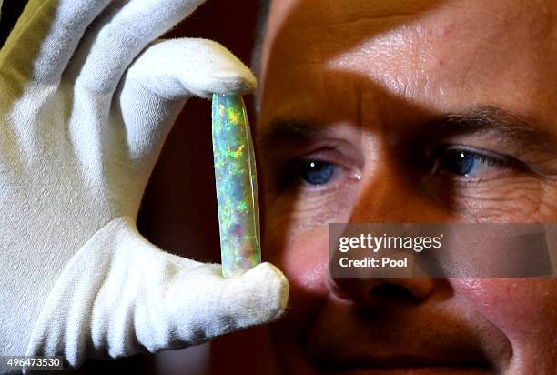 Director of the South Australian Museum Brian Oldman holds The Virgin Rainbow Opal ahead of Camilla, Duchess of Cornwall's viewing of a selection of...