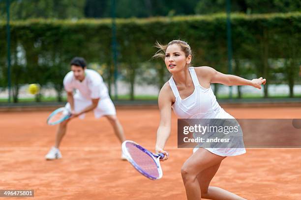 couple playing tennis - mixed doubles stockfoto's en -beelden