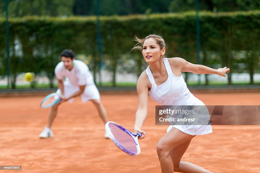 Couple playing tennis