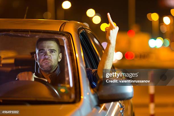 mad driver showing the finger - doigt dhonneur stockfoto's en -beelden