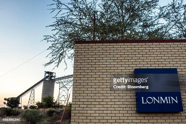 Lonmin Plc sign sits on the wall outside the Marikana platinum mine, operated by Lonmin Plc, in Marikana, South Africa, on Monday, Nov. 9, 2015....