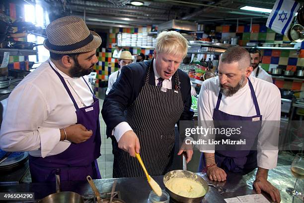 Mayor of London, Boris Johnson , Israeli chef Assaf Granite and and Uri Navon cook together at the Machneyuda restaurant on November 10, 2015 in...
