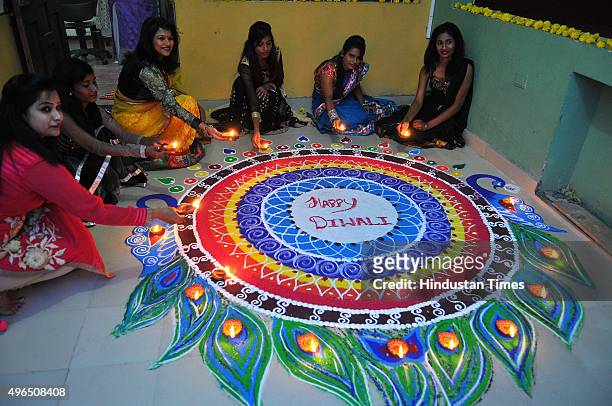 Women making grand rangoli and enjoying Diwali festivities on November 10, 2015 in Indore, India. Festival of light Diwali is one of the most...