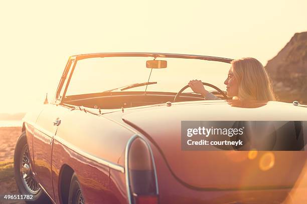 woman driving a convertible car at the beach. - road trip new south wales stock pictures, royalty-free photos & images