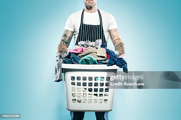 dad with tattoos does laundry - washing basket stock pictures, royalty-free photos & images