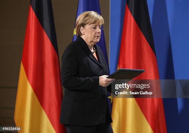 German Chancellor Angela Merkel arrives to give a statement to the media following news earlier in the day that former German Chancellor Helmut...