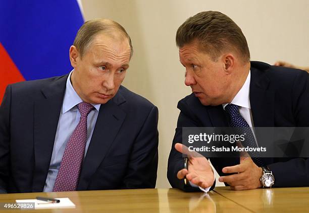 Russian President Vladimir Putin listens to Gazprom CEO Alexei Miller during a Russian-Kuwait meeting in Bocharov Ruchey State Residence on November...